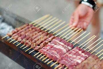 Arrosticini being cooked on a special grill.